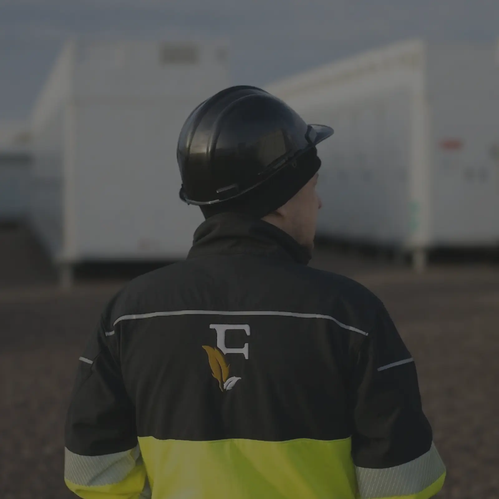 Worker in safety gear observing site